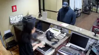 An unidentified man is robbing a Red Roof Inn hotel.